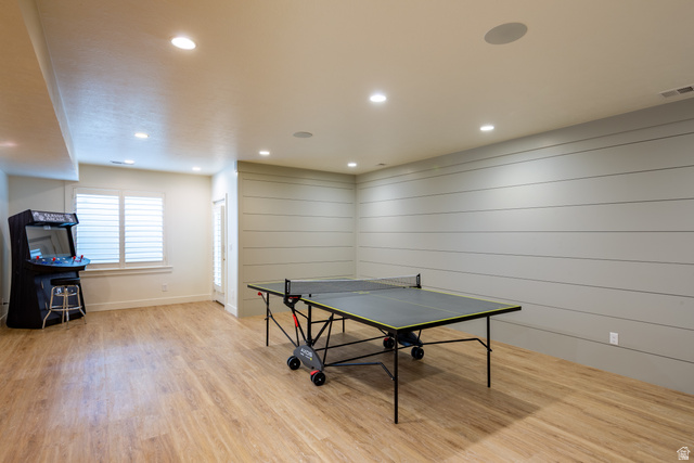630 East Center Street Alpine, UT 84004 - Photo 64 of 115 Spacious recreation room featuring wood-finish flooring, shiplap accent wall, recessed lighting, and built-in ceiling speakers
