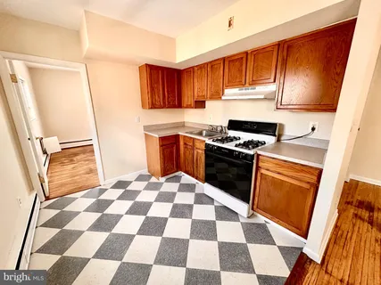 a kitchen with a stove a sink and a refrigerator