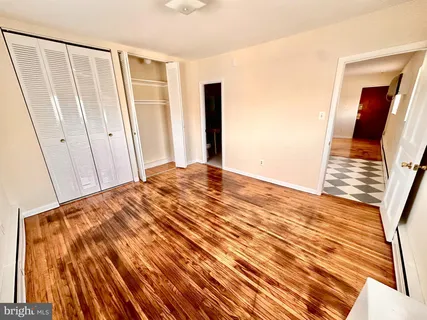 a view of a room with wooden floor and white walls