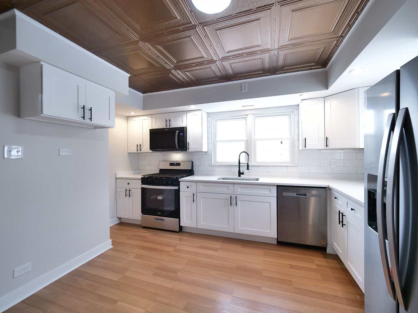 2926 Prairie Avenue Brookfield, IL 60513 - Photo 14 of 49 a kitchen with stainless steel appliances granite countertop a stove a sink and a refrigerator