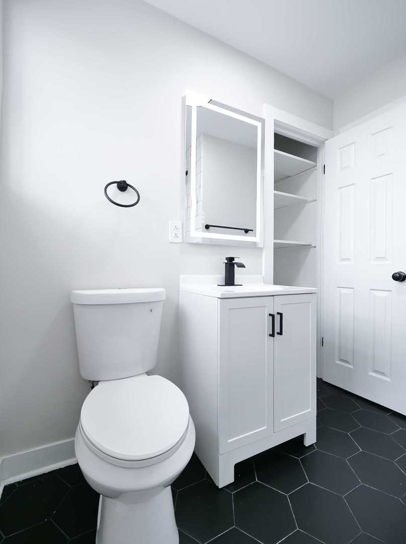 2926 Prairie Avenue Brookfield, IL 60513 - Photo 17 of 49 a white toilet sitting next to a bathroom sink