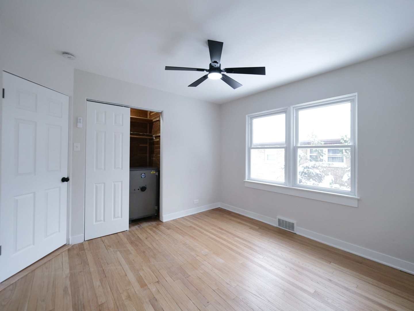 2926 Prairie Avenue Brookfield, IL 60513 - Photo 22 of 49 a view of an empty room with a window and wooden floor