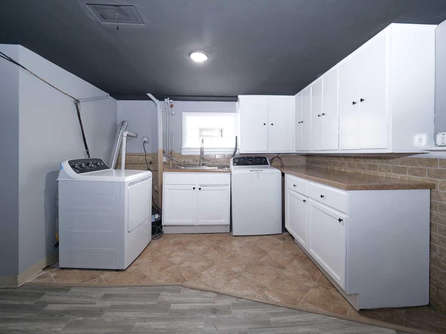 2926 Prairie Avenue Brookfield, IL 60513 - Photo 36 of 49 a kitchen with white cabinets sink and white appliances