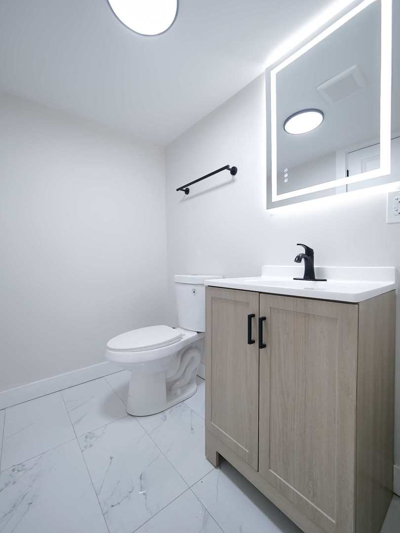 2926 Prairie Avenue Brookfield, IL 60513 - Photo 38 of 49 a bathroom with a sink toilet and mirror