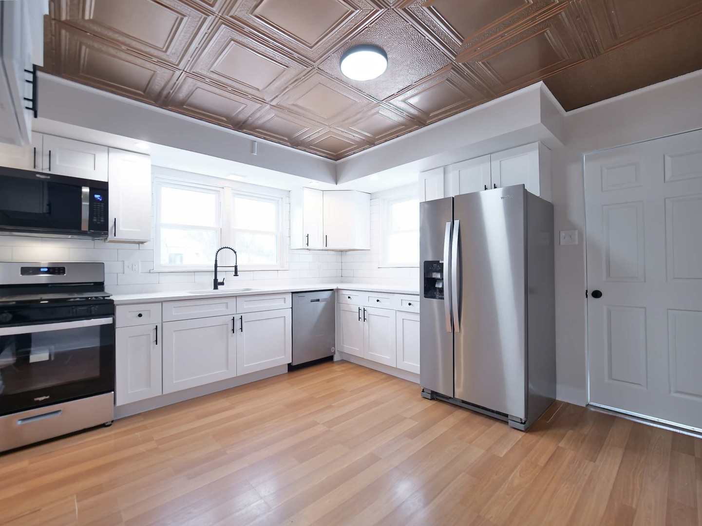2926 Prairie Avenue Brookfield, IL 60513 - Photo 10 of 49 a kitchen with stainless steel appliances a refrigerator a sink a stove a microwave and cabinets