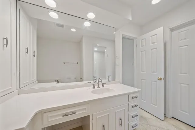 a bathroom with a sink double vanity and a mirror