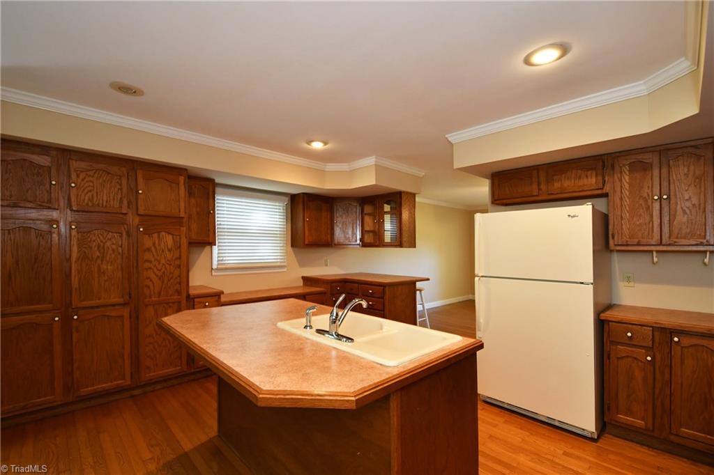 6280 Styers Ferry Road Clemmons, NC 27012 - Photo 4 of 19 Kitchen with lots of cabinet space, hardwood floors, large island, desk and built-in pantry.