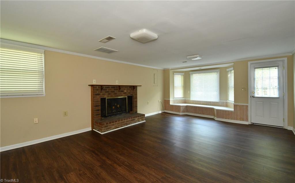 6280 Styers Ferry Road Clemmons, NC 27012 - Photo 9 of 19 Lower level den with new floors, fireplace and window seat.