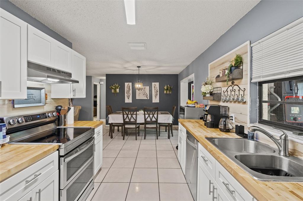 12989 Linden Drive Spring Hill, FL 34609 - Photo 11 of 28 a kitchen with stainless steel appliances granite countertop a sink and stove