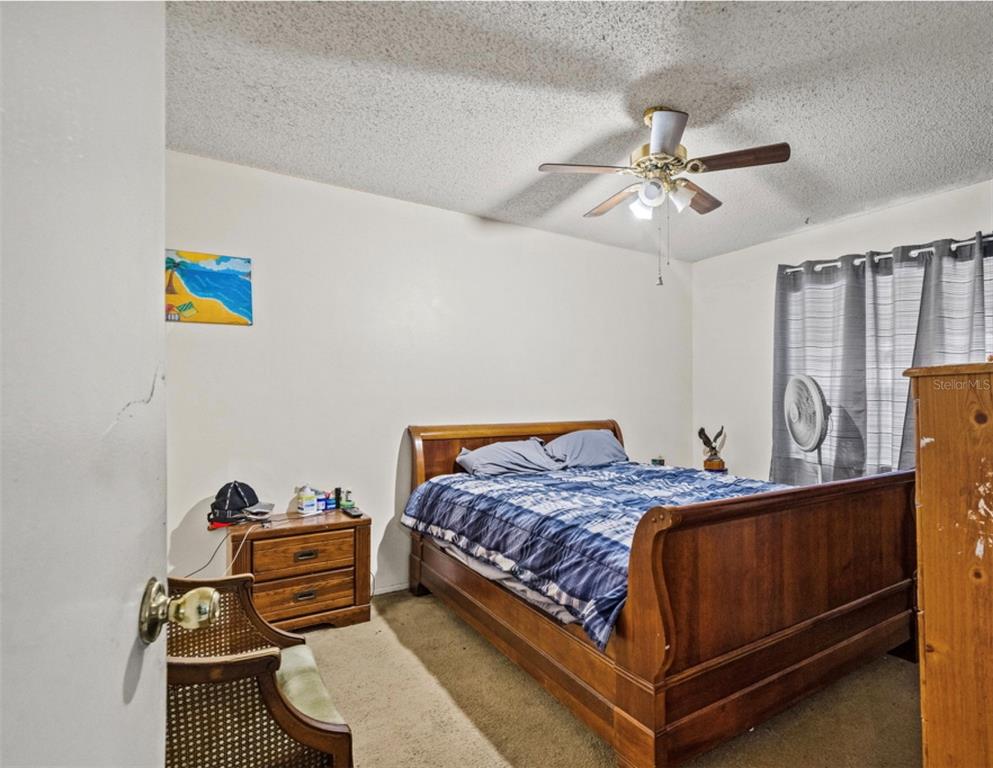 12989 Linden Drive Spring Hill, FL 34609 - Photo 17 of 28 a bedroom with a bed and wooden floor
