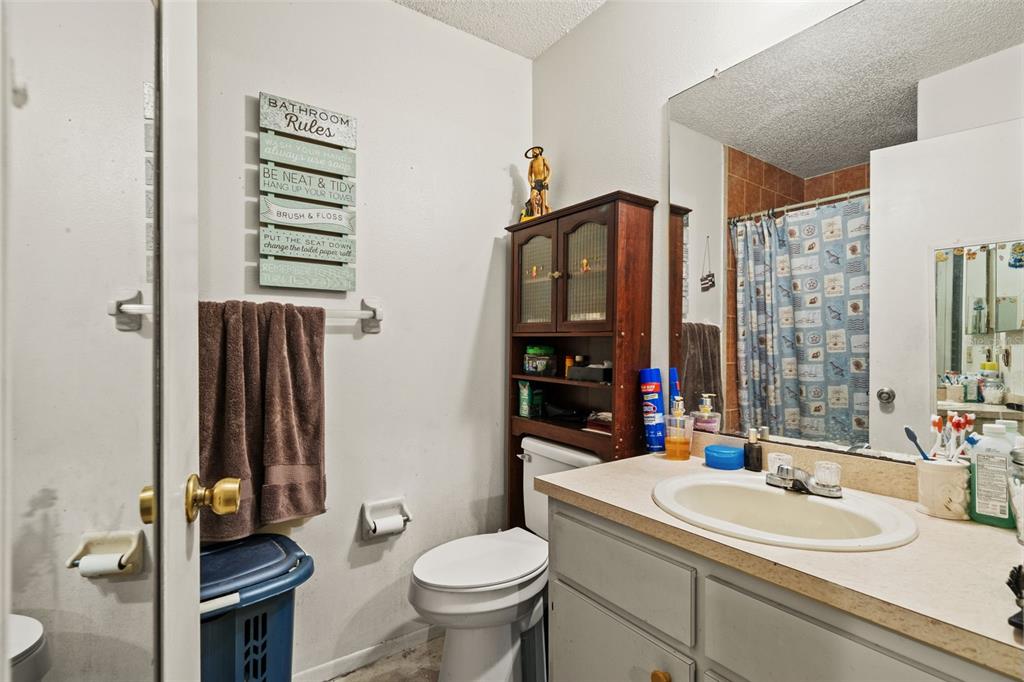 12989 Linden Drive Spring Hill, FL 34609 - Photo 19 of 28 a bathroom with a sink toilet and shower