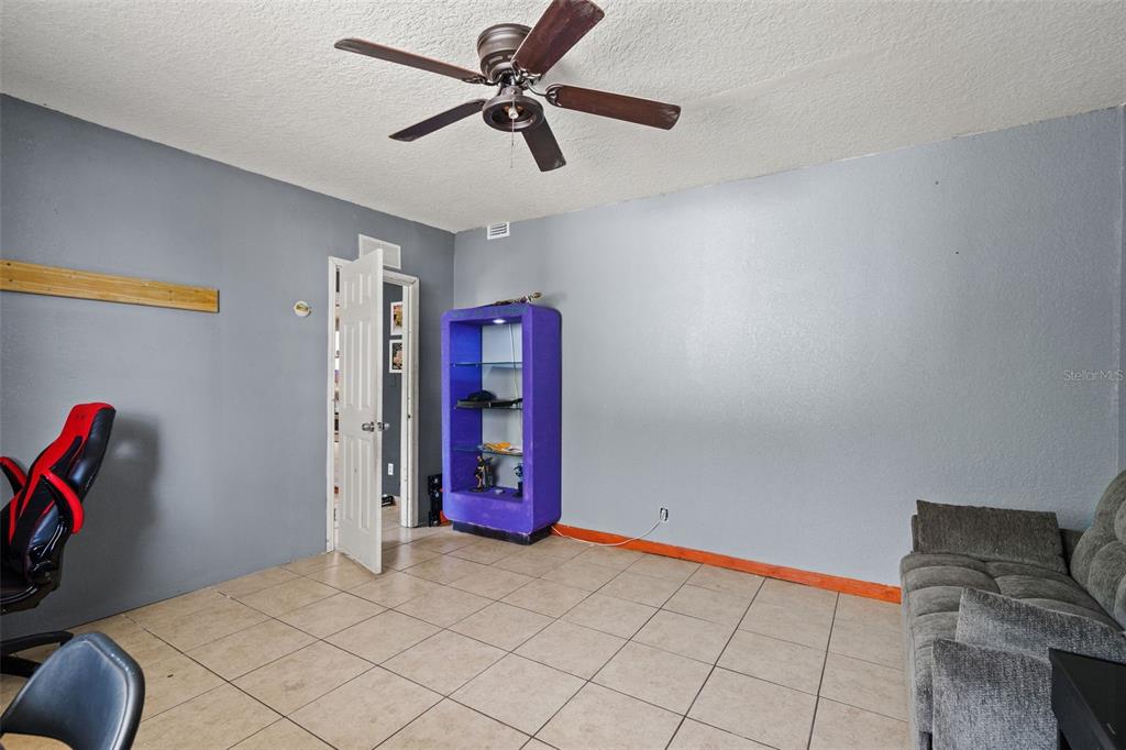 12989 Linden Drive Spring Hill, FL 34609 - Photo 22 of 28 a view of a livingroom with a chandelier fan and windows