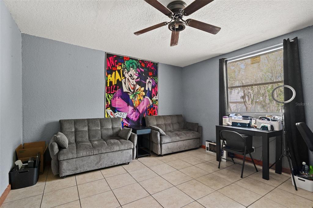 12989 Linden Drive Spring Hill, FL 34609 - Photo 4 of 28 a living room with furniture and a flat screen tv