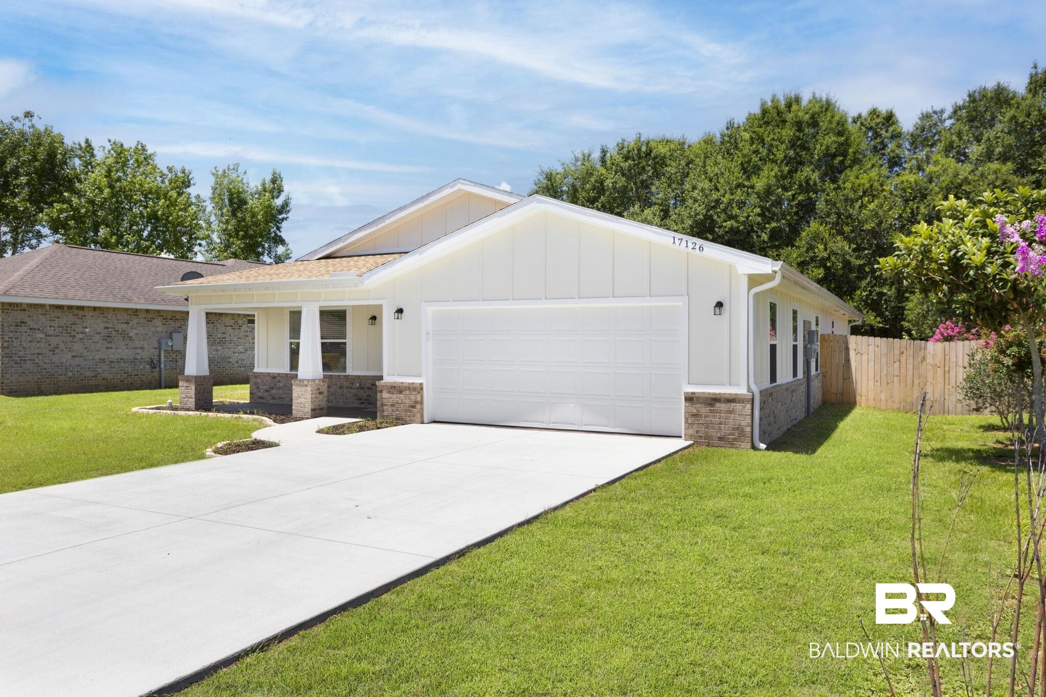 17126 Sugar Loop Foley, AL 36535 - Photo 27 of 28 View of front facade featuring a garage, board and batten siding, concrete driveway, and brick siding