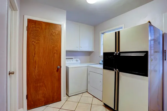 a kitchen with a refrigerator and cabinets