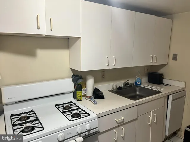a kitchen with a sink and cabinets