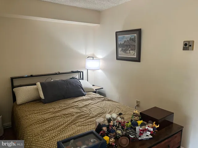 a bedroom with a bed and a dresser