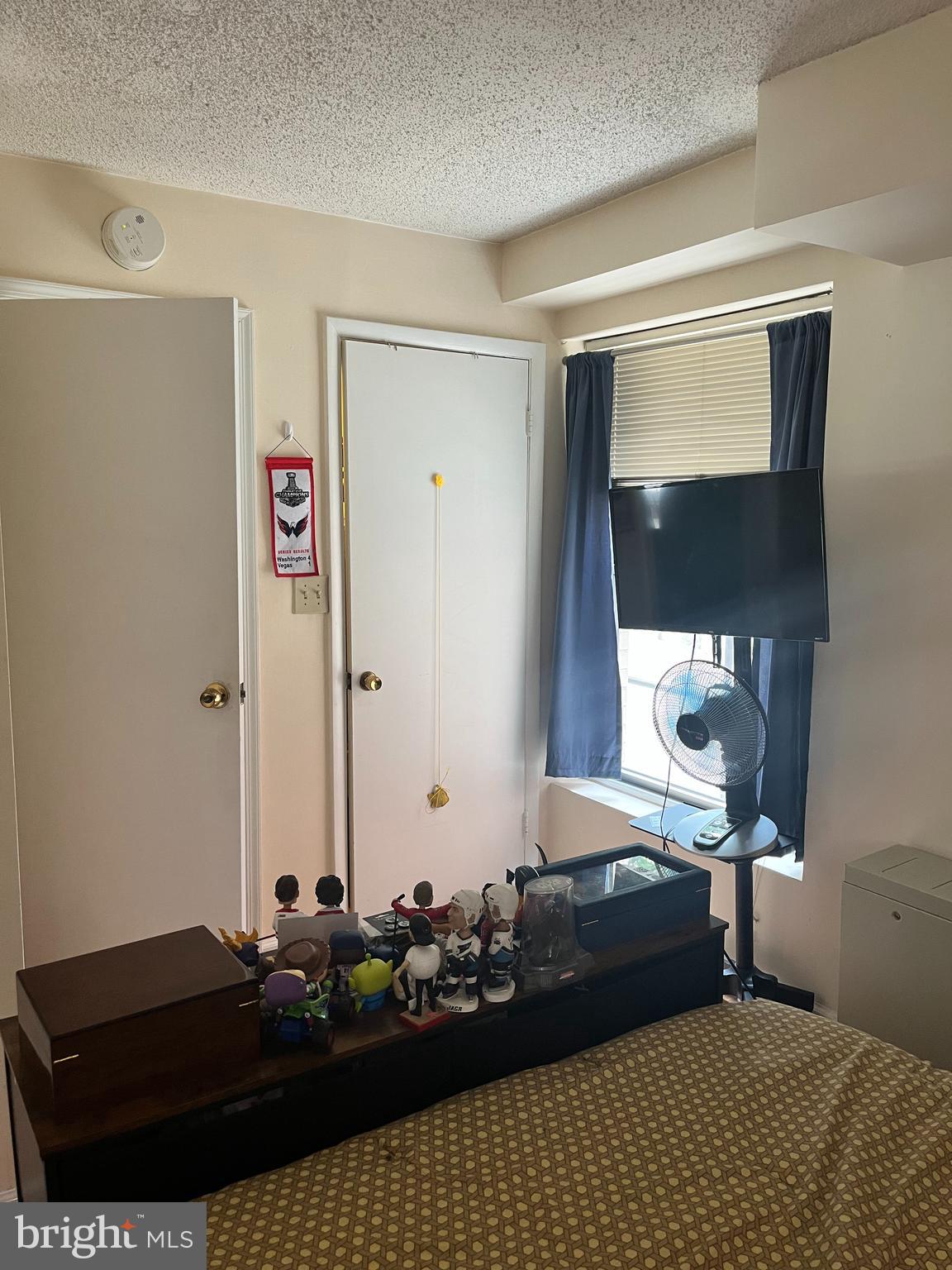 1239 Vermont Avenue Northwest, Unit 104 Washington, DC 20005 - Photo 19 of 30 a bedroom with a bed and window