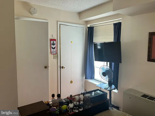 a room with wooden floor and mirror