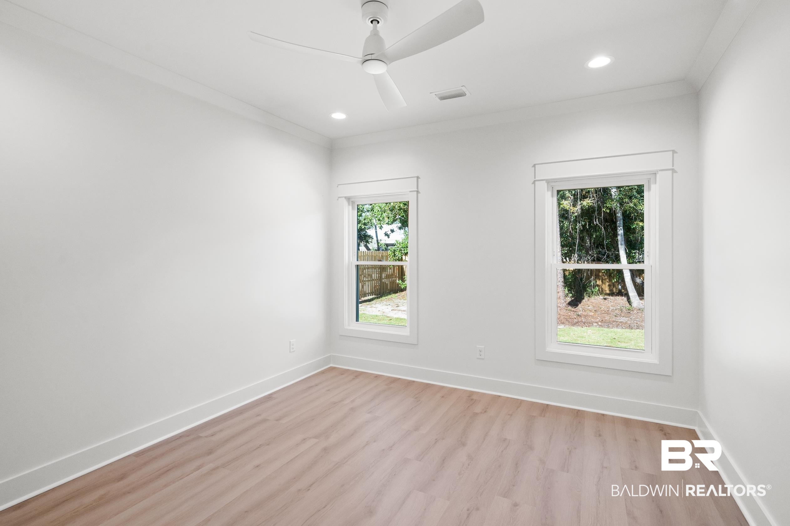 28889 Canal Road Orange Beach, AL 36561 - Photo 23 of 55 Unfurnished room featuring ceiling fan, light hardwood / wood-style floors, and ornamental molding