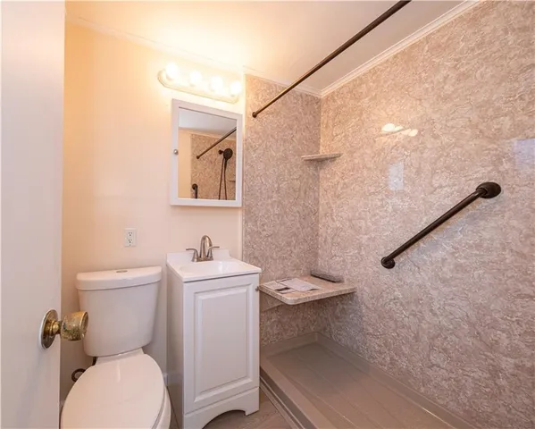 a white toilet sitting next to a bathroom sink