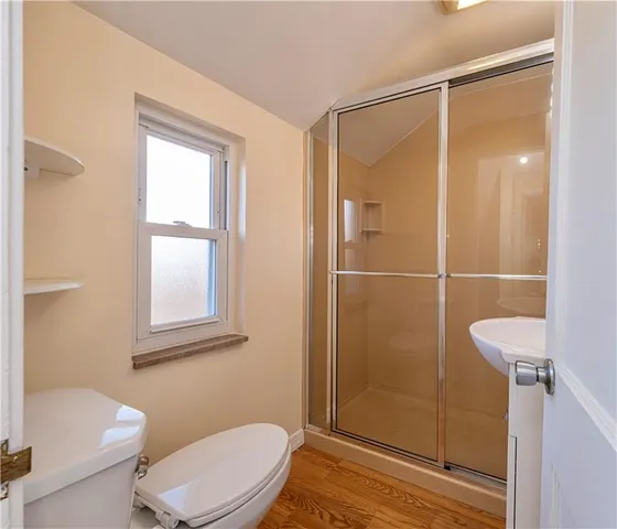 a bathroom with a toilet a sink and shower