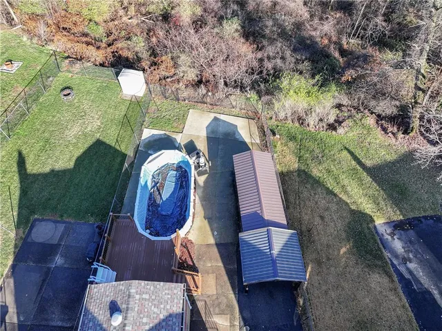 an aerial view of residential house with outdoor space and parking