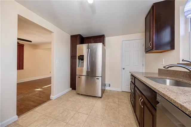 a kitchen with stainless steel appliances granite countertop a refrigerator and a sink