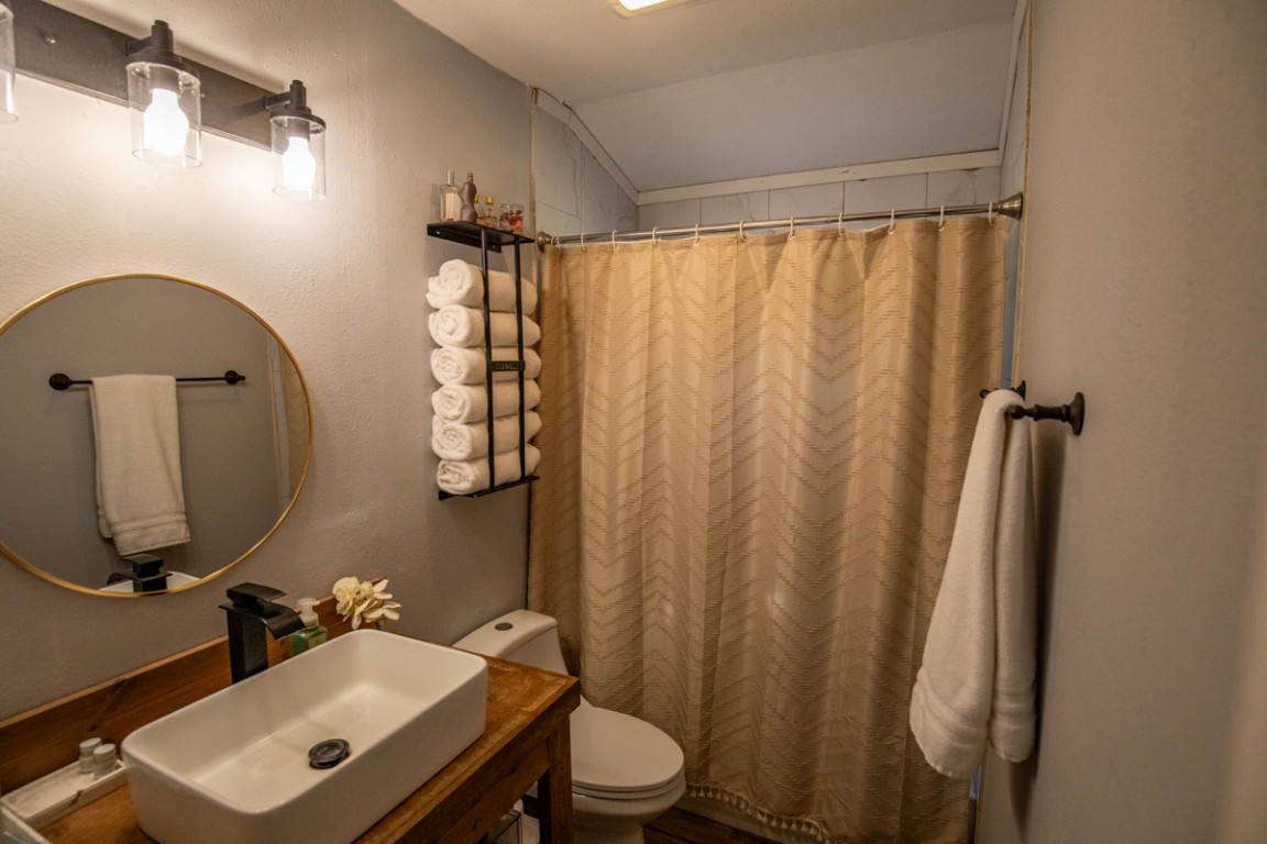 143 Harrison Road Beeville, TX 78102 - Photo 12 of 39 Bathroom with lofted ceiling, vanity, and a shower with shower curtain