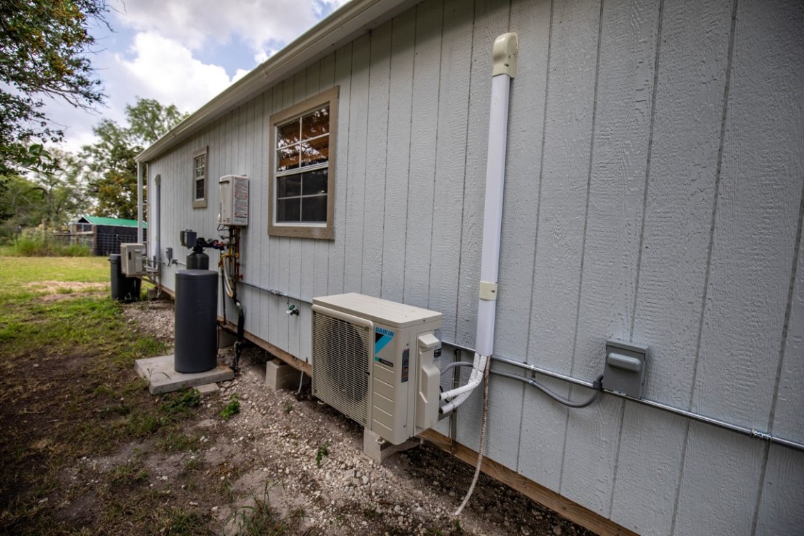143 Harrison Road Beeville, TX 78102 - Photo 15 of 39 View of property exterior featuring a cooling unit