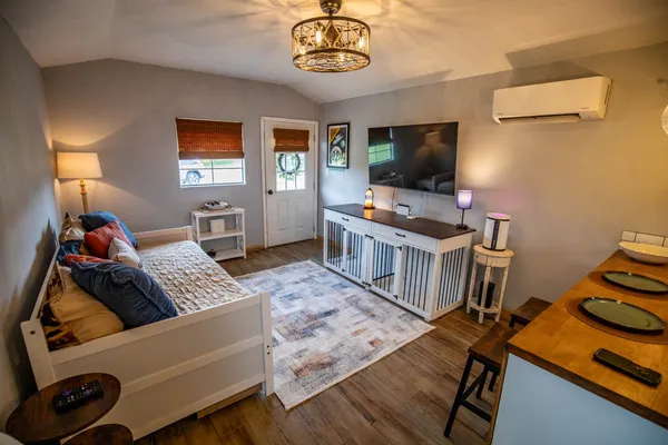 a kitchen with wooden floor and stainless steel appliances