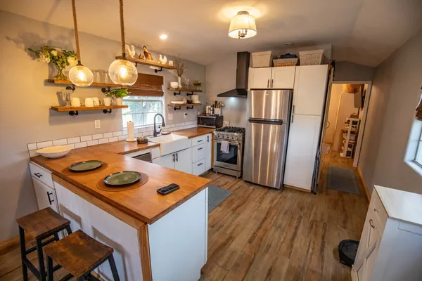 a kitchen with sink cabinets and wooden floor