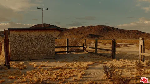 a view of a house with a wooden fence