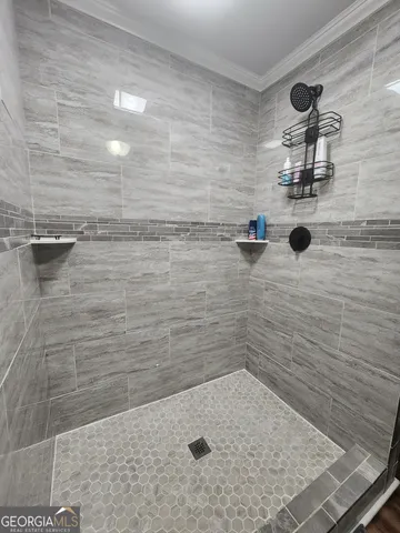 a living room with a toilet a sink and a mirror