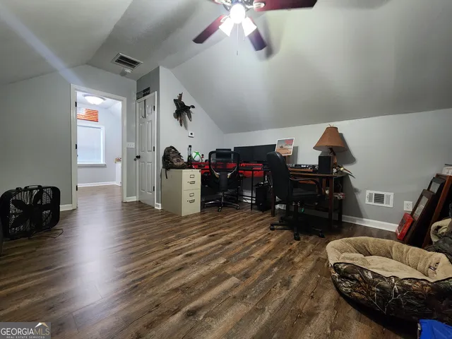 a living room with hard wood floors and a window
