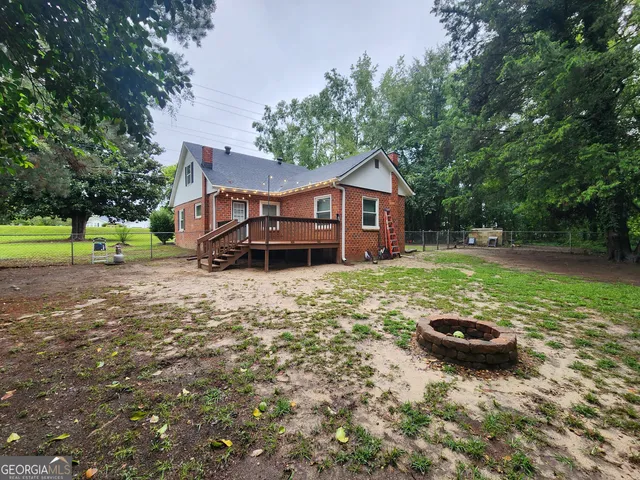 a view of a house with a yard and sitting area