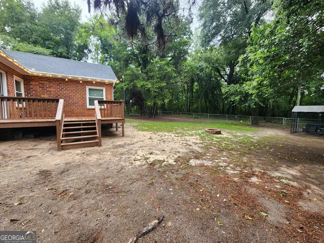 a backyard of a house with barbeque oven