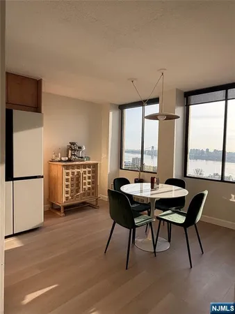 a bedroom with a bed window and table chair