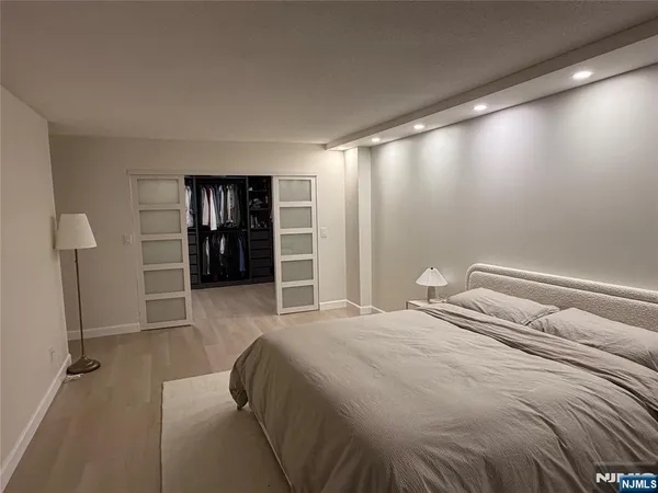 a bedroom with a bed and walk in closet