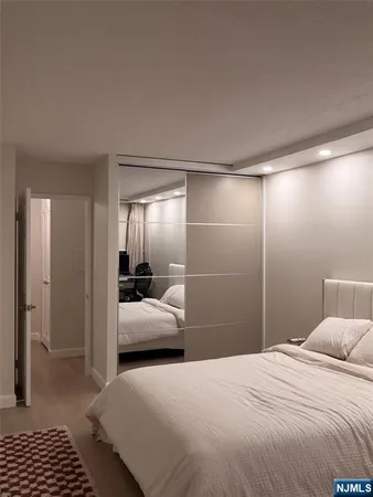 a spacious bedroom with a bed a table and a window