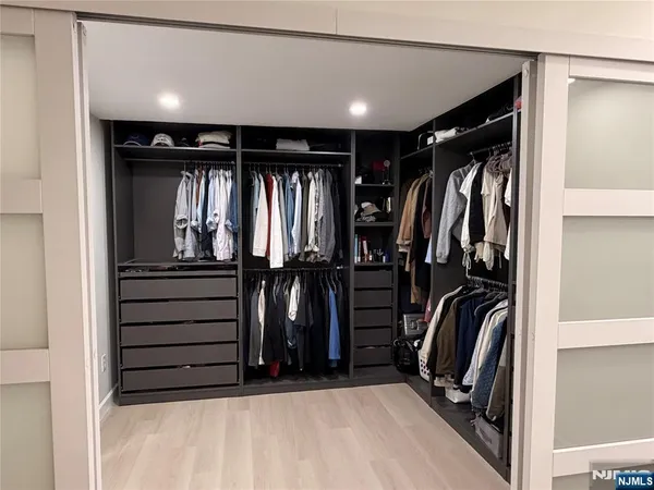 a bedroom with a bed and a television