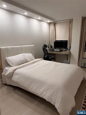 a spacious bedroom with a bed and a large window