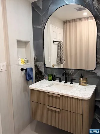 a bathroom with a sink and mirror