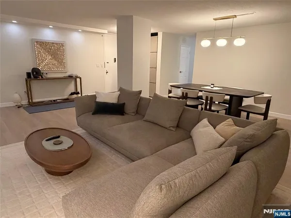a living room with furniture and a mirror