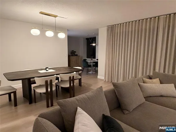 a living room with furniture a table and chairs