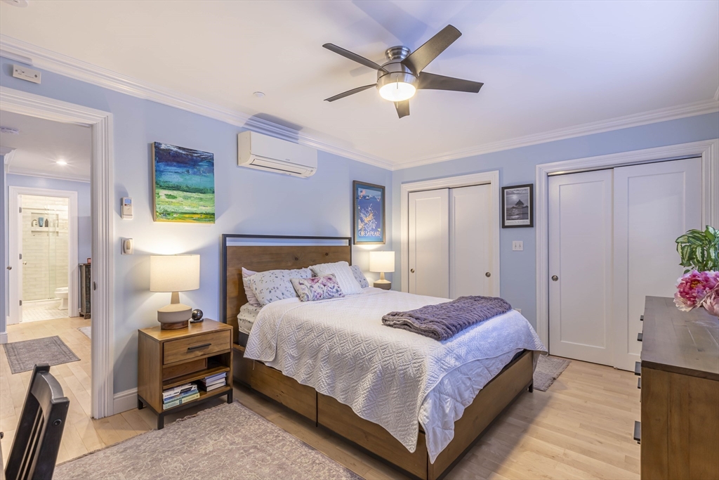 52 Cooper Street, Unit 2 Boston, MA 02113 - Photo 9 of 15 a bedroom with a bed and a chandelier