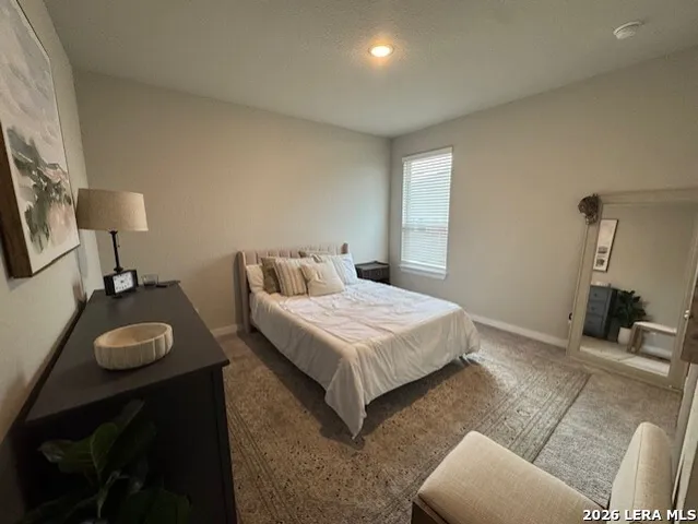 a bedroom with a bed and a lamp