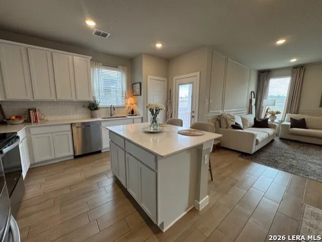 a kitchen with a sink and cabinets