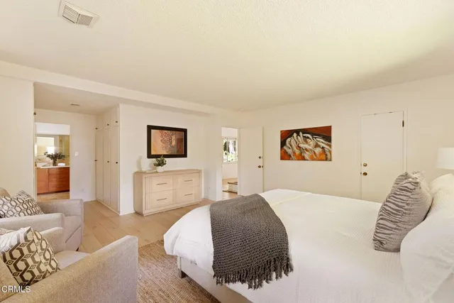 a bedroom with a bed and a couch