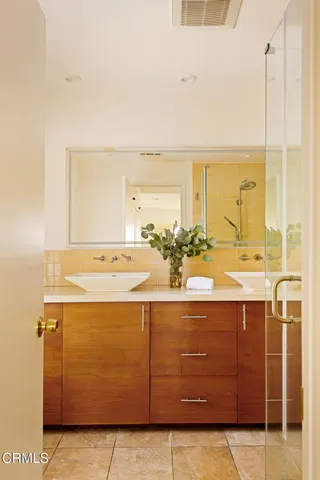 a bathroom with a sink vanity and mirror